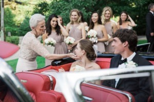 A bride greats her grandmother after her wedding at Lion Rock Farm in Connecticut. Photo by Kelly Kollar Photography.