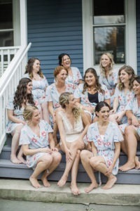 A bride and her bridesmaids in their robes before the wedding at Roundhouse in Beacon, New York. Photo by Kelly Kollar Photography.