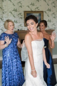 A bride with her mother and mother-in-law before her wedding at Hamilton Golf Club in New Jersey. Photo by Kelly Kollar Photography.