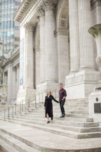 An engaged couple on the steps on the New York Public Library in Manhattan. Photo by Kelly Kollar Photography.