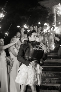 A bride and groom kiss during a sparkler send off after their wedding reception at Hamilton Farm Golf Club in New Jersey. Photo by Kelly Kollar Photography.