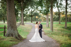 A bride and groom on their wedding day on the golf course at The Heritage Club at Bethpage on Long Island. Photo by Kelly Kollar Photography.