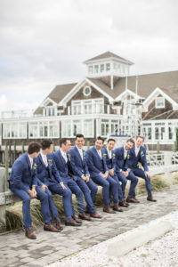 A groom and his groomsmen at a wedding at Peconic Bay Yacht Club on the North Fork of Long Island in New York. Photo by Kelly Kollar Photography.
