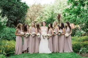 A bride and her bridesmaids at a wedding at Lion Rock Farm in Connecticut. Photo by Kelly Kollar Photography.