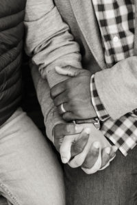 A same-sex couple hold hands for their engagement photos in Brooklyn. Photo by Kelly Kollar Photography.