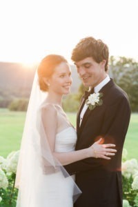 A bride and groom in the sunset on their wedding day at Lion Rock Farm in Connecticut. Photo by Kelly Kollar Photography.
