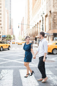 An engaged couple walk across the street in Manhattan. Photo by Kelly Kollar Photography.