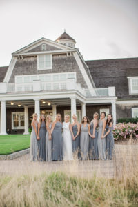 A bride and her bridesmaids at a wedding at Shelter Harbor Golf Club in Rhode Island. Photo by Kelly Kollar Photography.