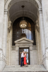 An engaged couple on the steps of the New York Public Library in Manhattan. Photo by Kelly Kollar Photography.