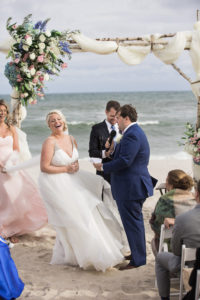 A bride and groom at their beach wedding ceremony at Oceanbleu in The Hamptons. Photo by Kelly Kollar Photography.