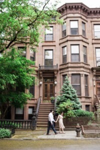 An engaged couple walk in Park Slope, Brooklyn. Photo by Kelly Kollar Photography.