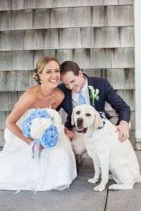 A bride and groom and their lab on their wedding day at Ram's Head Inn on Shelter Island in New York. Photo by Kelly Kollar Photography.