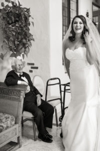 A bride greets her grandfather on her wedding day at Pleasantdale Chateau in New Jersey. Photo by Kelly Kollar Photography.