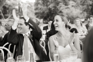 A bride and groom laugh during their wedding reception at Ram's Head Inn on Shelter Island in New York. Photo by Kelly Kollar Photography.