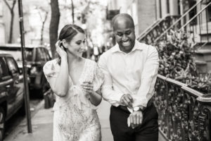 An engaged couple walk in the West Village for their engagement photos. Photo by Kelly Kollar Photography.