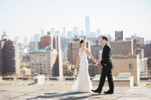 A bride and groom walk on the roof on their wedding day at Studio 450 in Manhattan. Photo by Kelly Kollar Photography.
