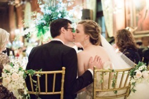 A bride and groom kiss at their wedding reception at The University Club in Manhattan. Photo by Kelly Kollar Photography.